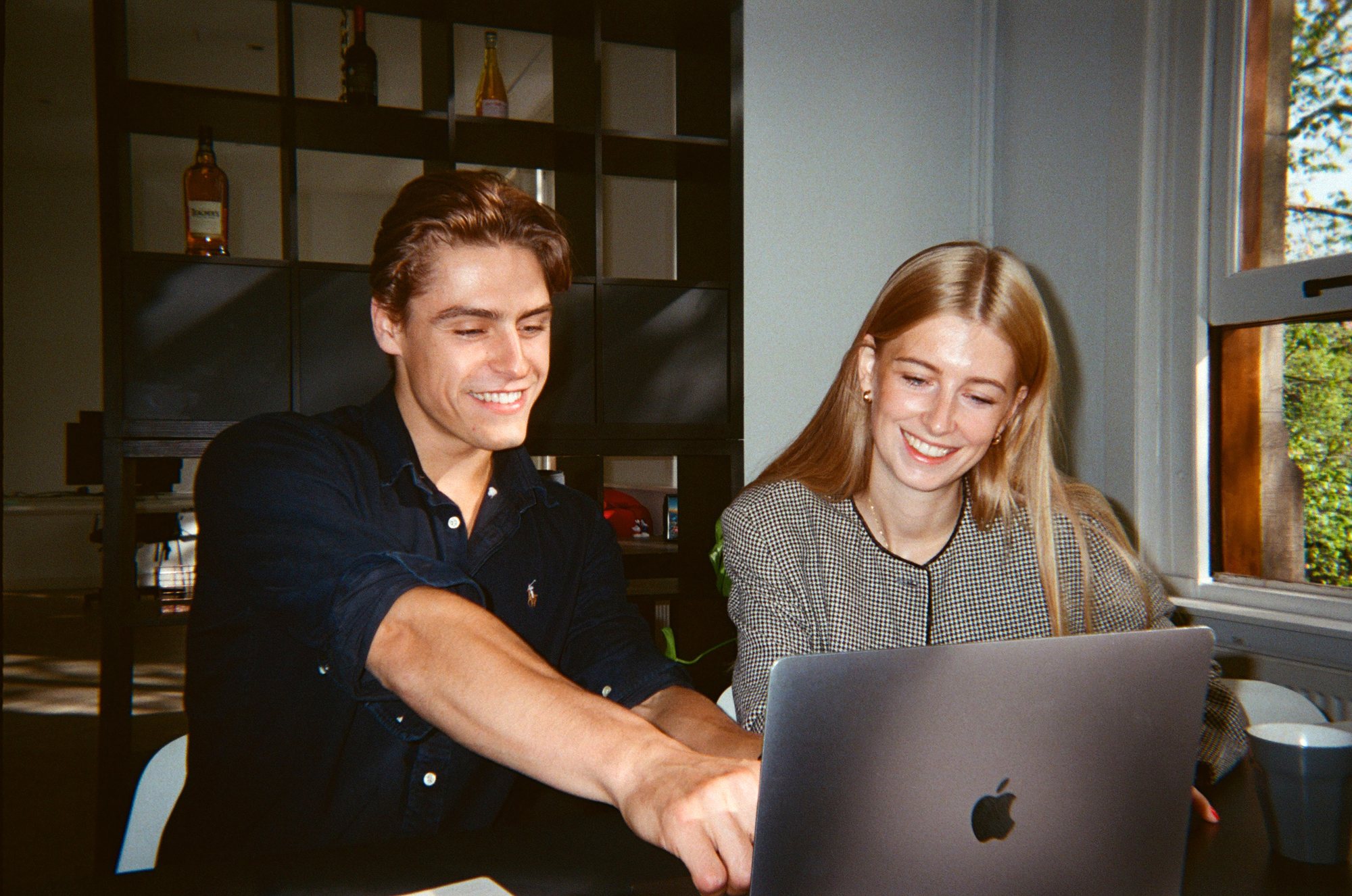 Colleagues looking at a laptop together