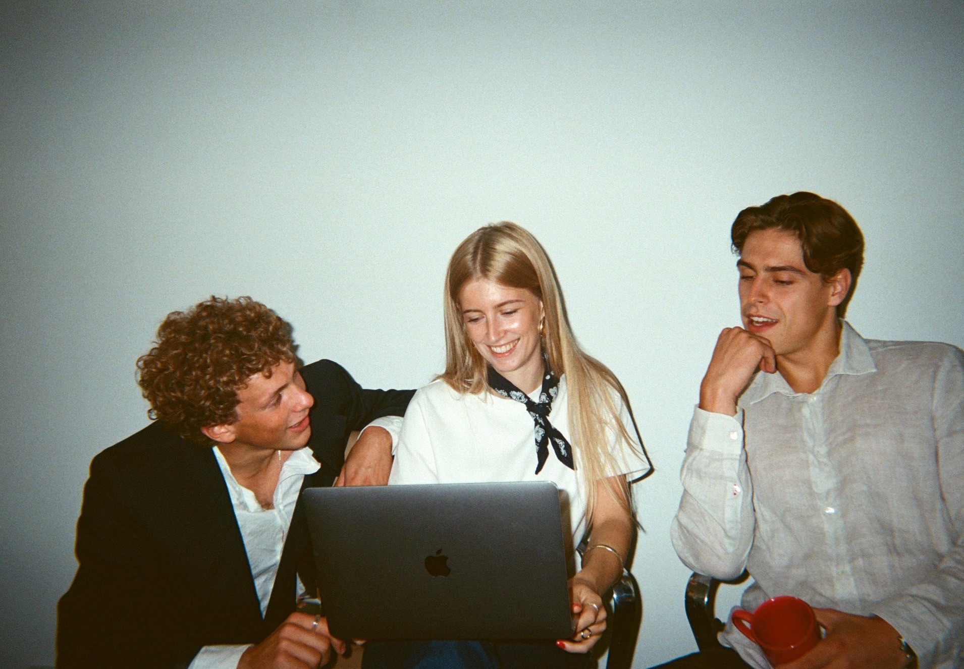 Three colleagues working together on a laptop