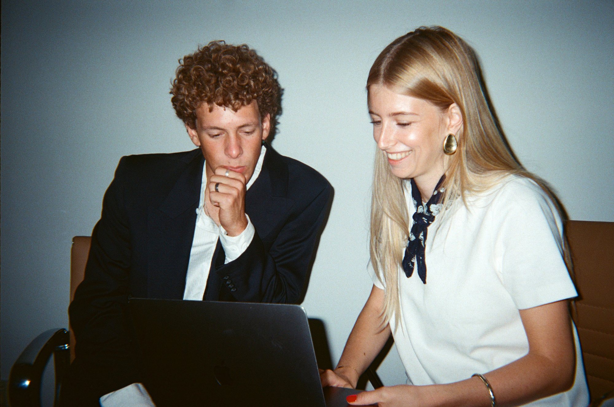 Two colleagues looking at a laptop together