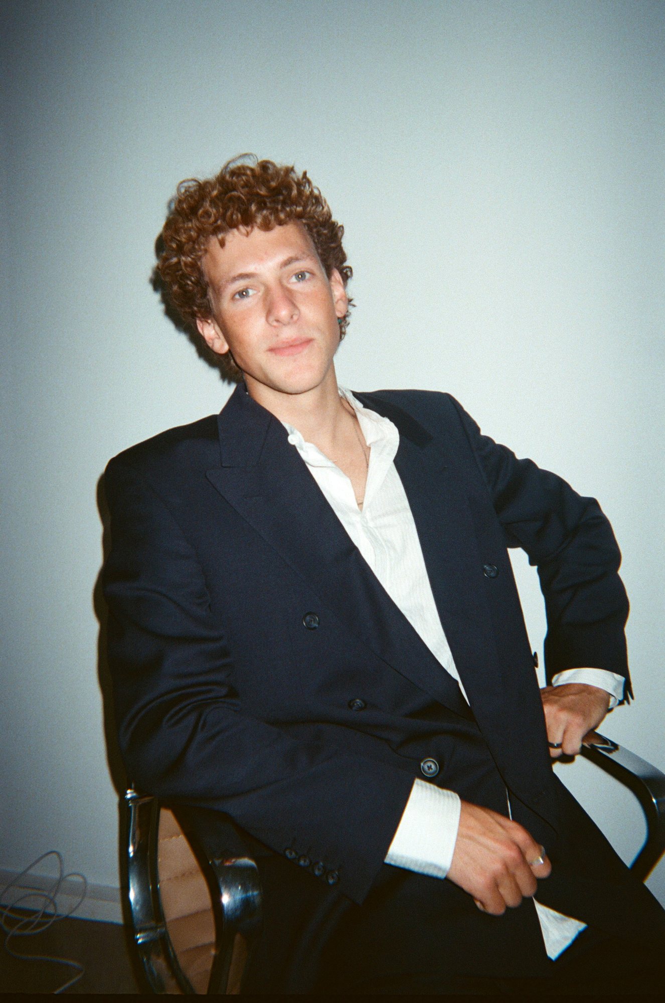 A colleague in a blazer looking into the camera