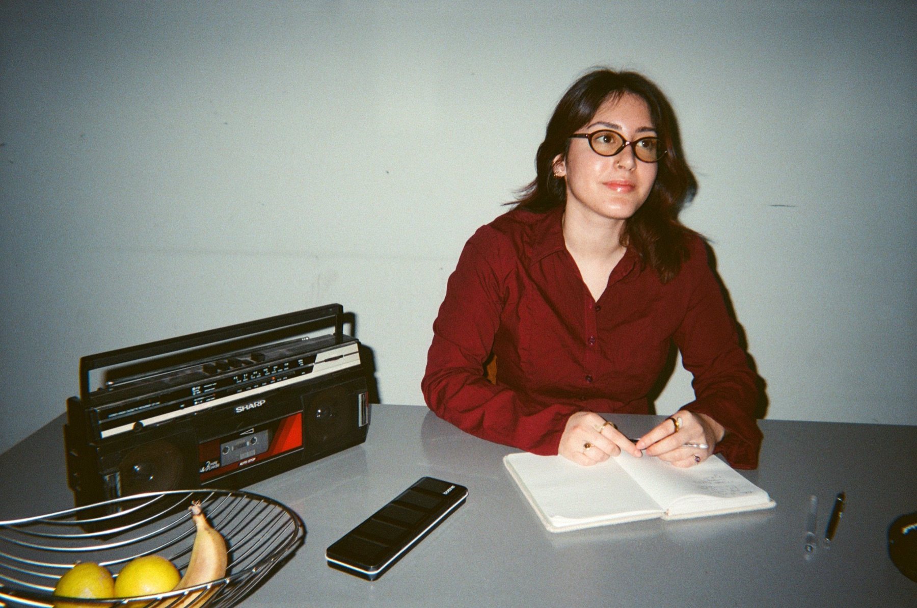 Colleague writing at a table with a radio beside her