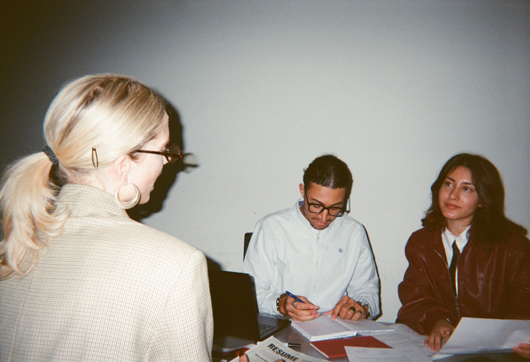 Three colleagues working together at a table